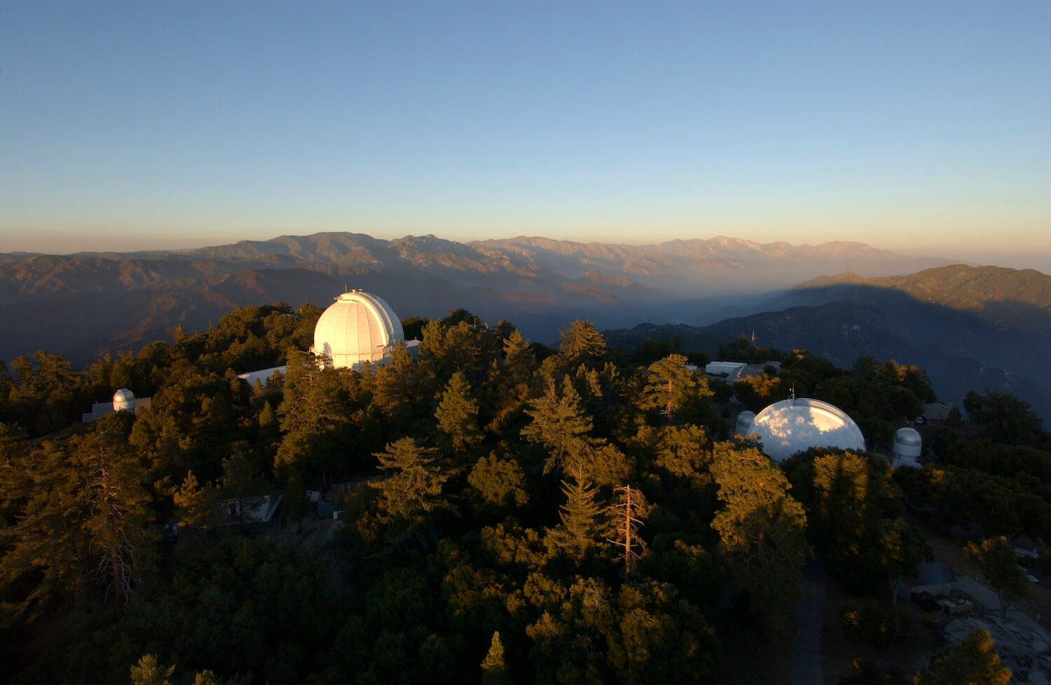 Image of observatory facility domes on a mountaintop.