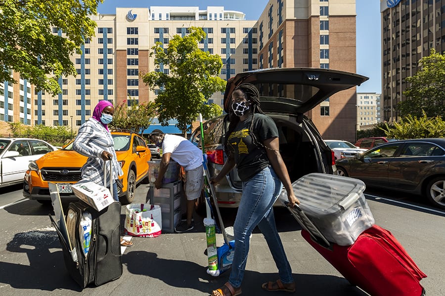 Freshman nursing student and new Piedmont Central resident Amy Sarr (right) unpacks the car with her parents.