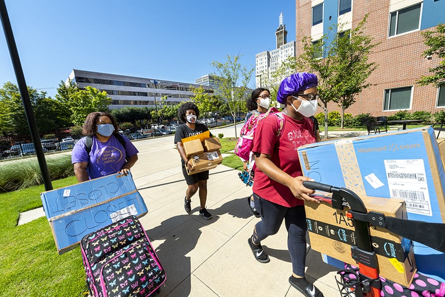Freshman Azaree Morsell (second from left) gets help from her mom, Allana Morsell (left) and Tahira Morsell and Shayla Morsell as she moves into Piedmont Central.