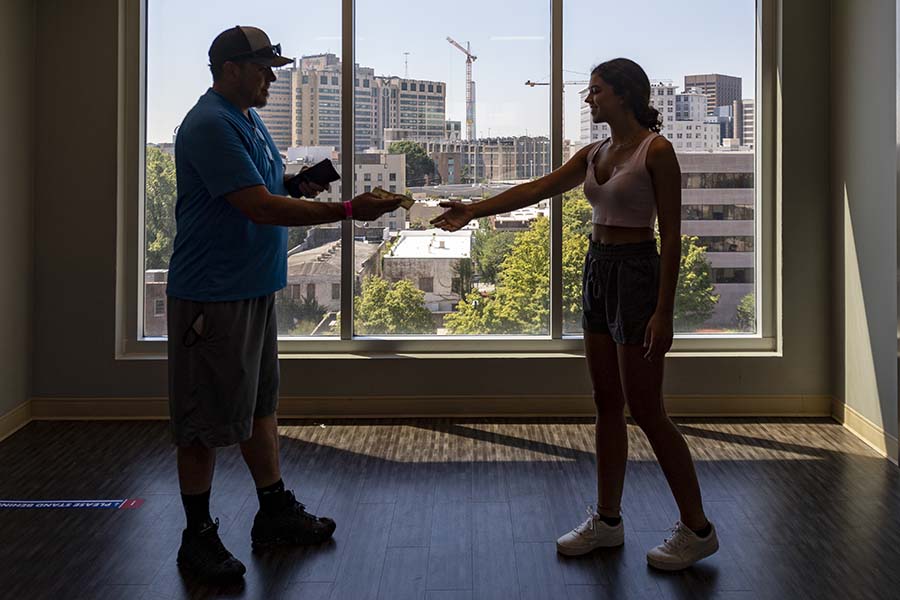 Michael Kessler hands daughter Sarah Kessler some spending money Tuesday after helping her move into a residence hall on Georgia State University’s Atlanta Campus.