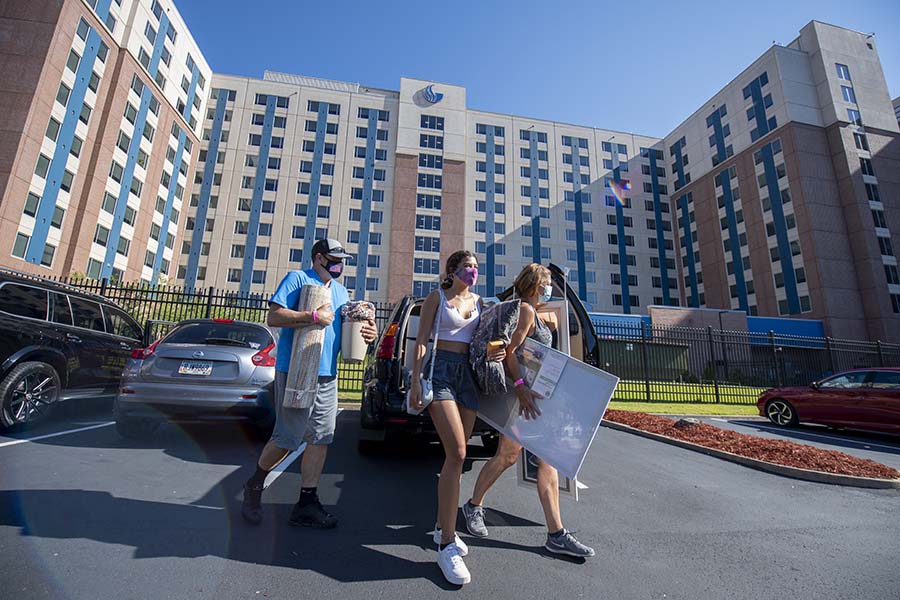 Sarah Kessler (center), an incoming freshman, moves into her residence hall on the Atlanta Campus Tuesday with help from parents Michael Kessler and Shelley Brown.
