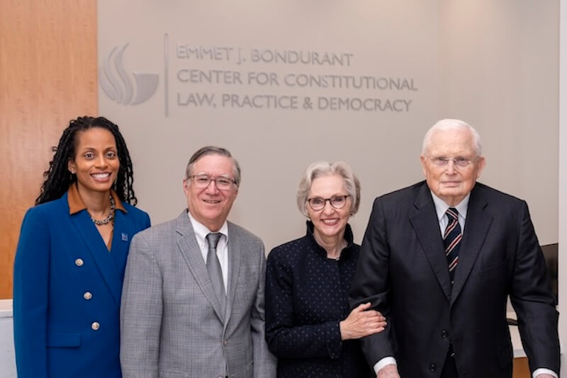 A group of four standing inside of the new Emmet J. Bondurant Center for Constitutional Law, Practice & Democracy
