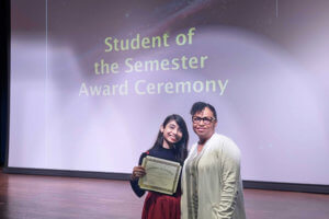 woman holding certificate and posing with another woman
