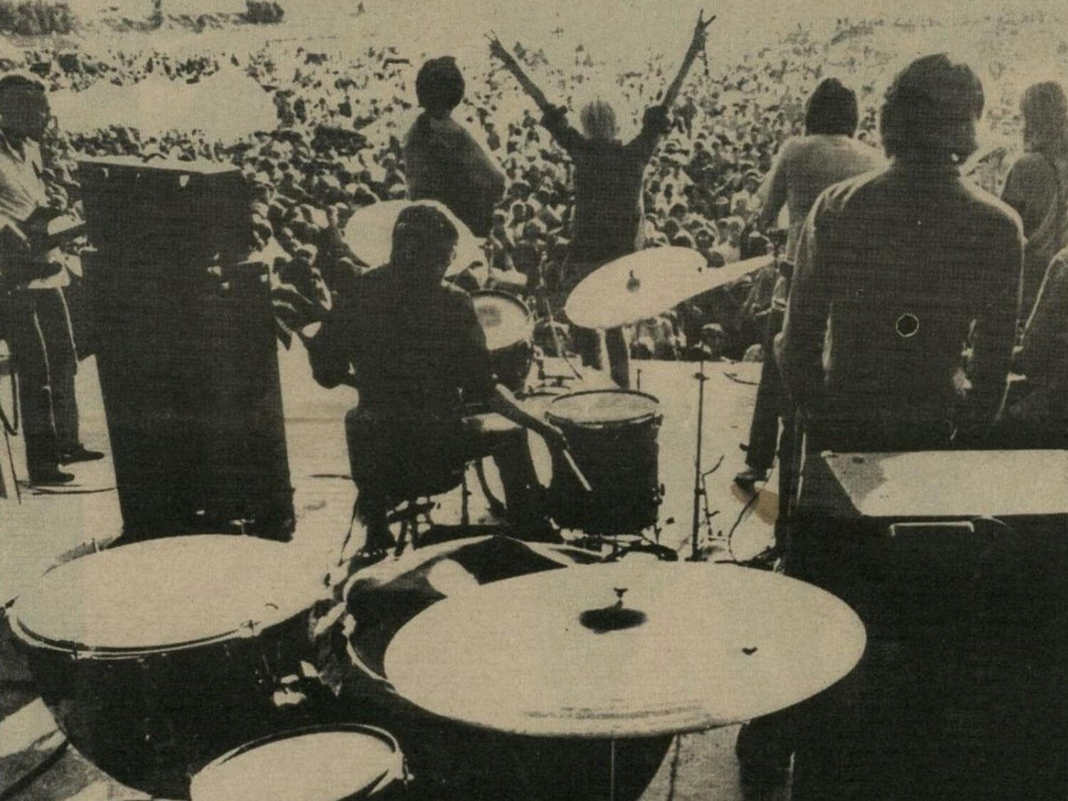 a band onstage in front of a large crowd