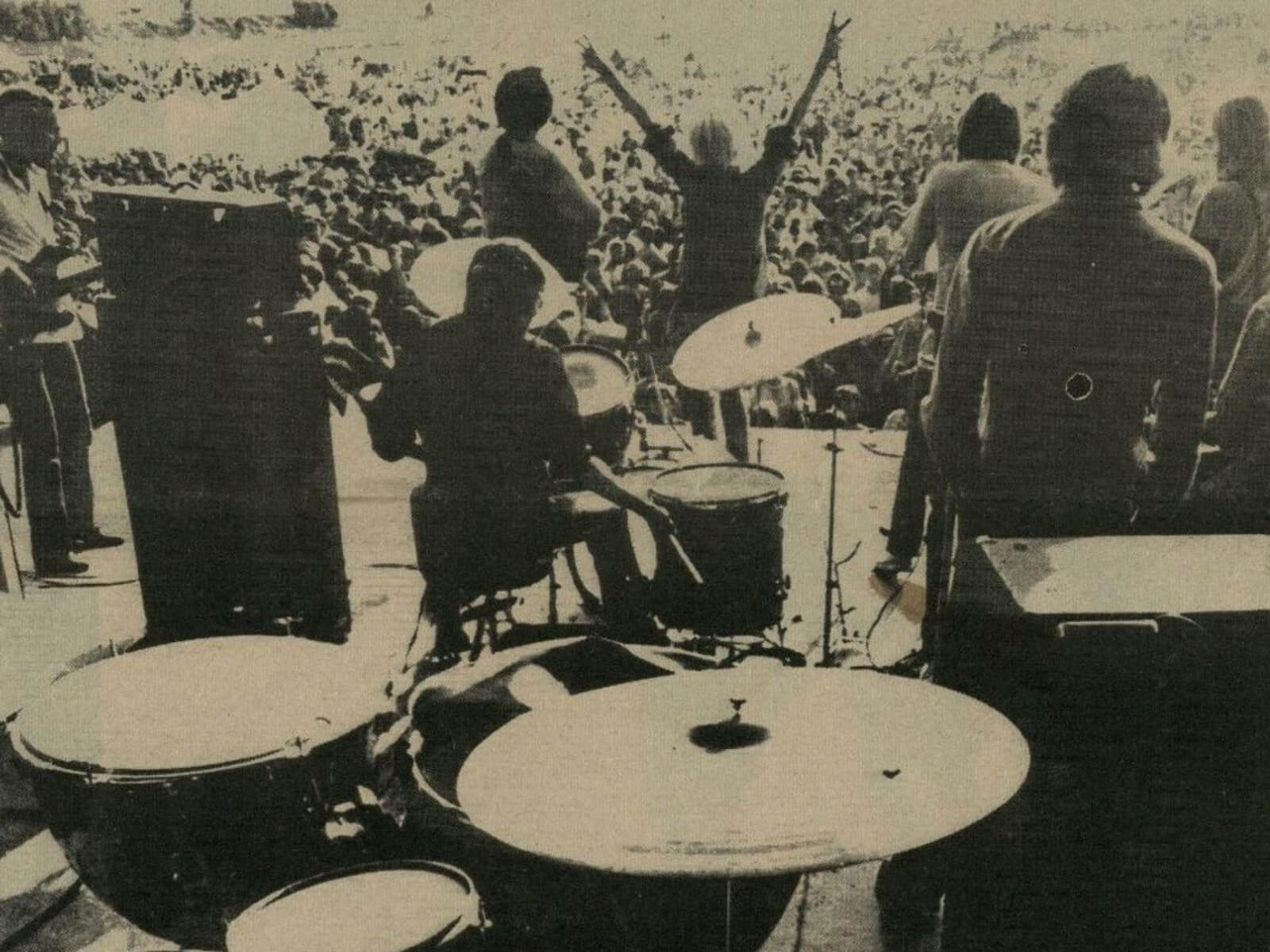 a band onstage in front of a large crowd