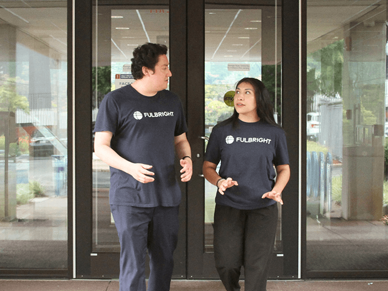 Mark Reyes and a Fulbright Fellow walking and talking.