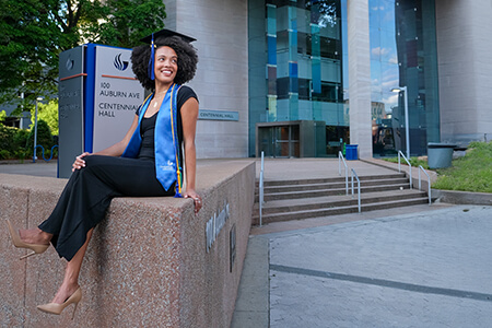 Garcia-Hector celebrating her graduation in front of Centennial Hall.