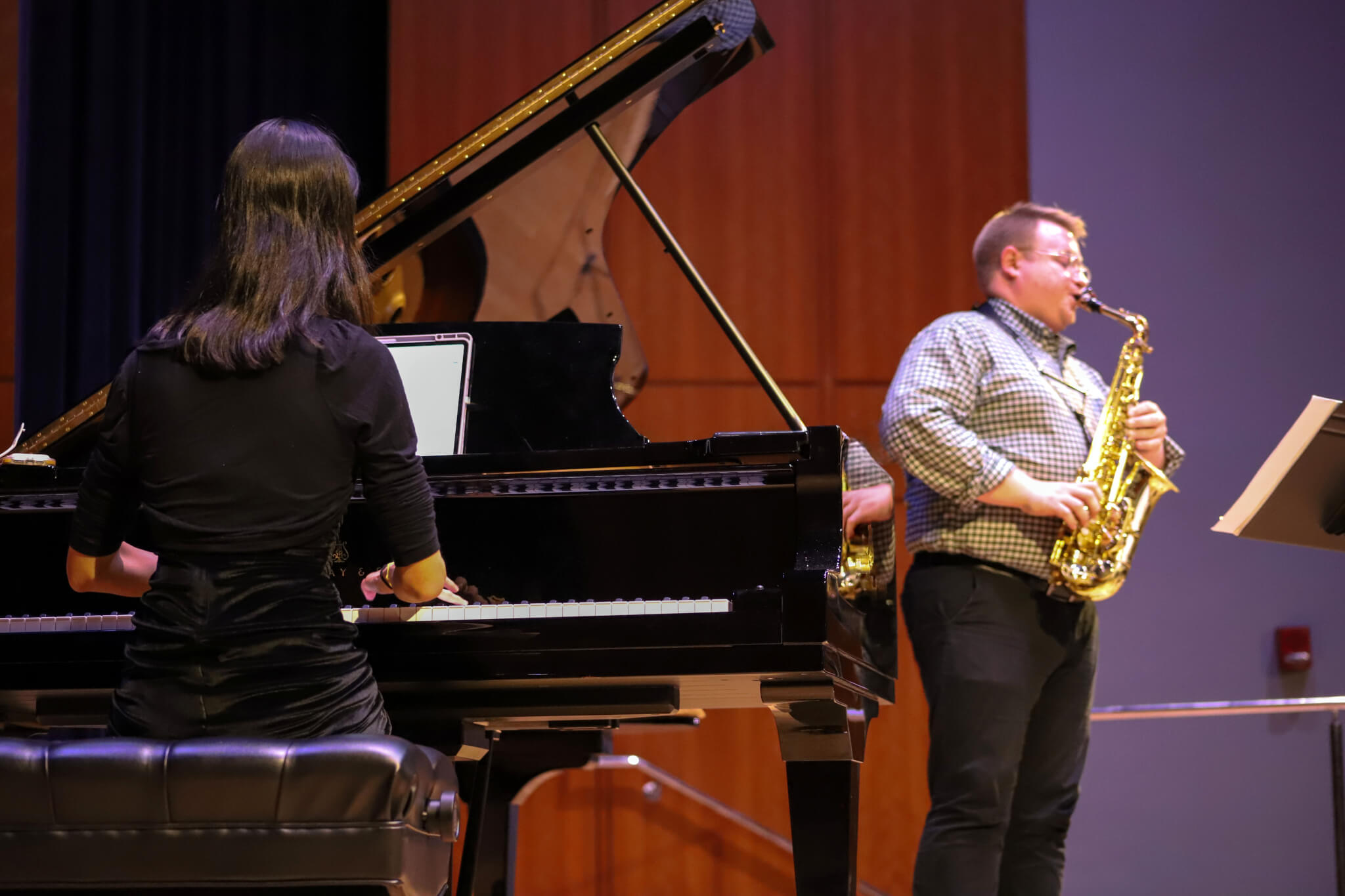 A pianist accompanies a saxophone player.