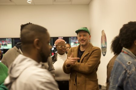 A professor guides students on a tour.