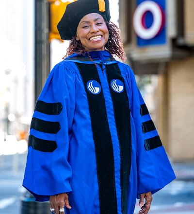 Female graduate in academic regalia.