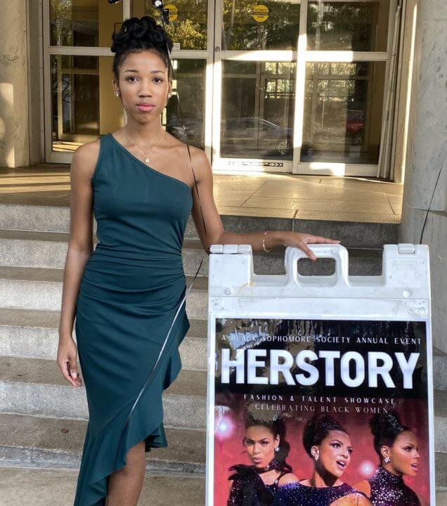Myla Williams in front of HERSTORY.