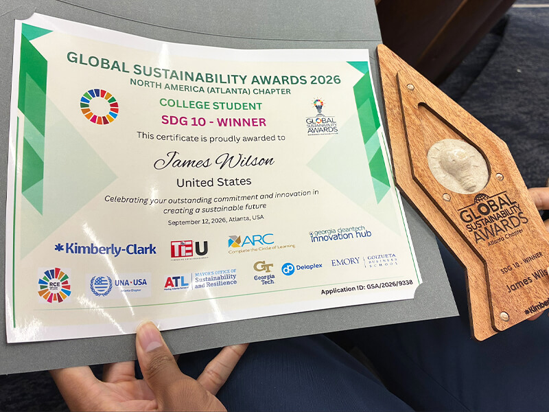 Image of a certificate and a wooden award.