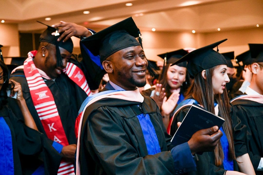 School of Public Health Master of Public Health, Ph.D. and bachelor's degree students, wearing their regalia, celebrate their graduation