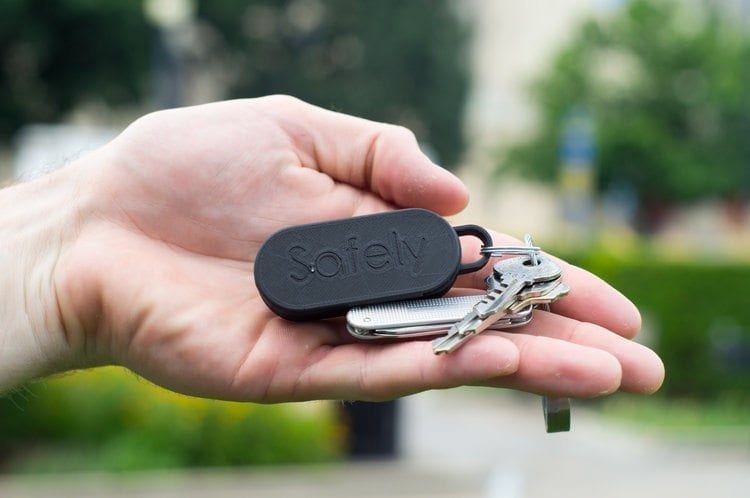 GoSafely keychain held up in an open palm