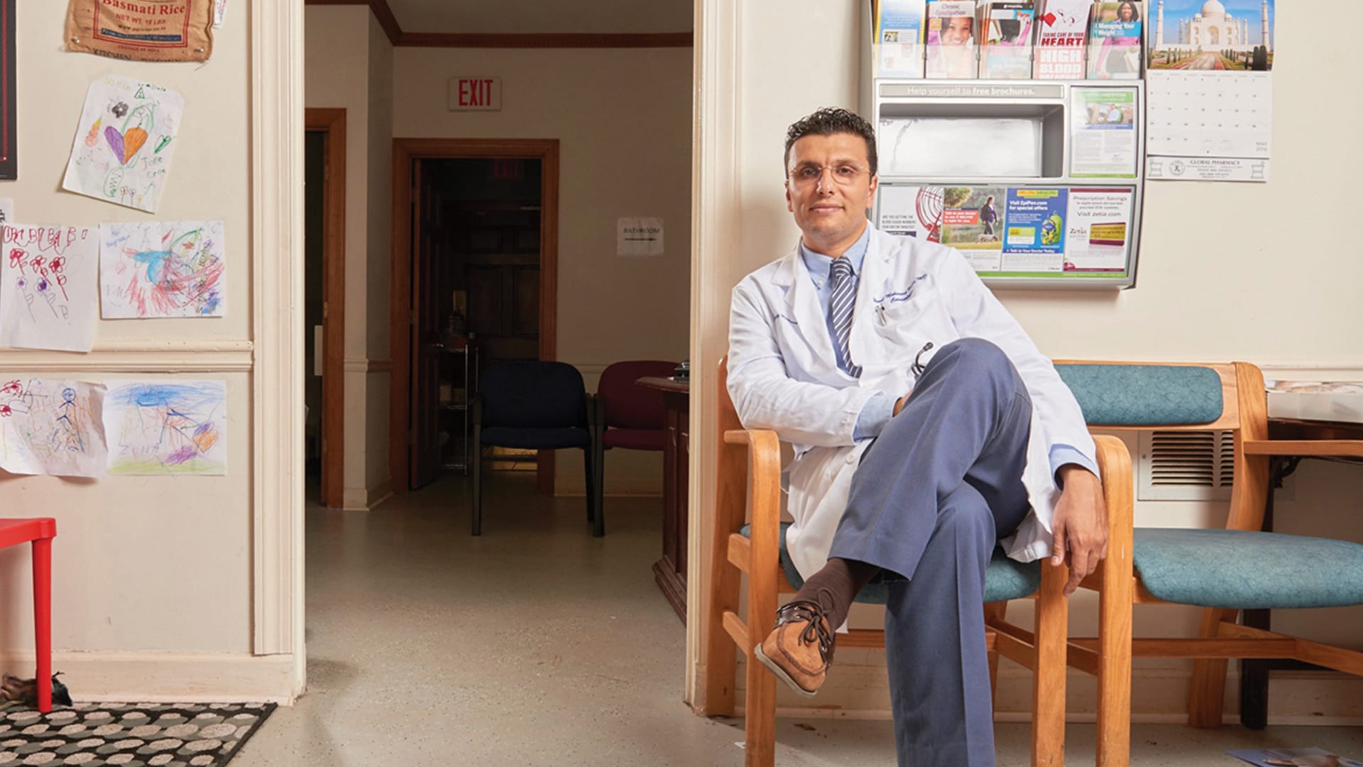 Heval Kelli (B.A. ’08) sitting in his office.