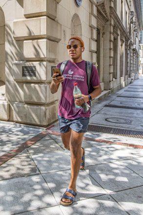 Ausar Simmonds, RCB, Honors and 1913 student walks to class through Fairlie Poplar.