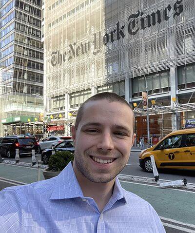 Daniel Varitek stands in front of the New York Times building.