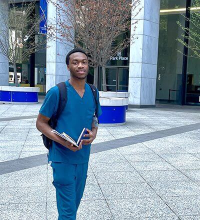 Chinedu Odedo walks past the 25 Park Place Building at Georgia State.