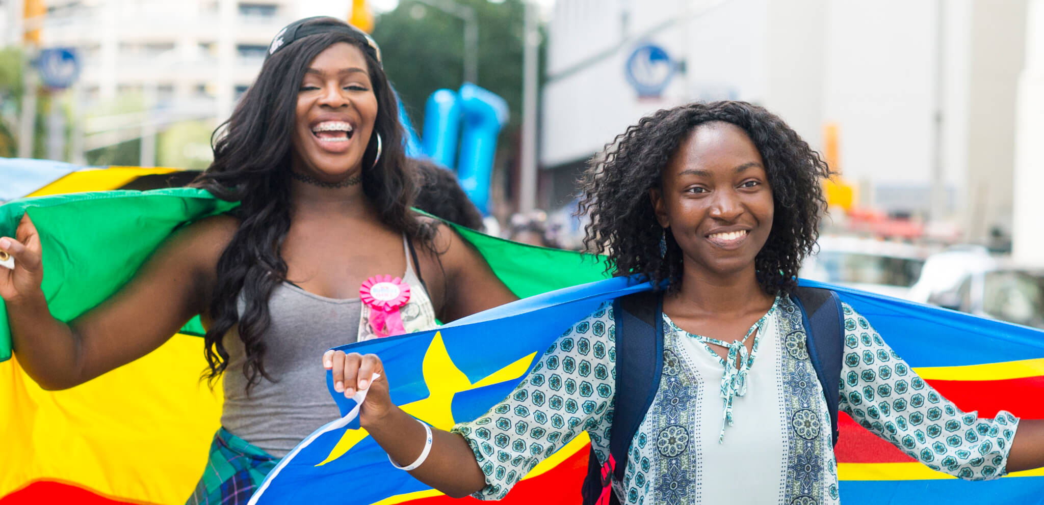 Two students wrapped in flags from other countries
