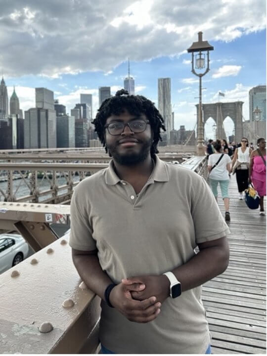 KeyShawn Phillips standing on a dock with the New York City skyline in the background.