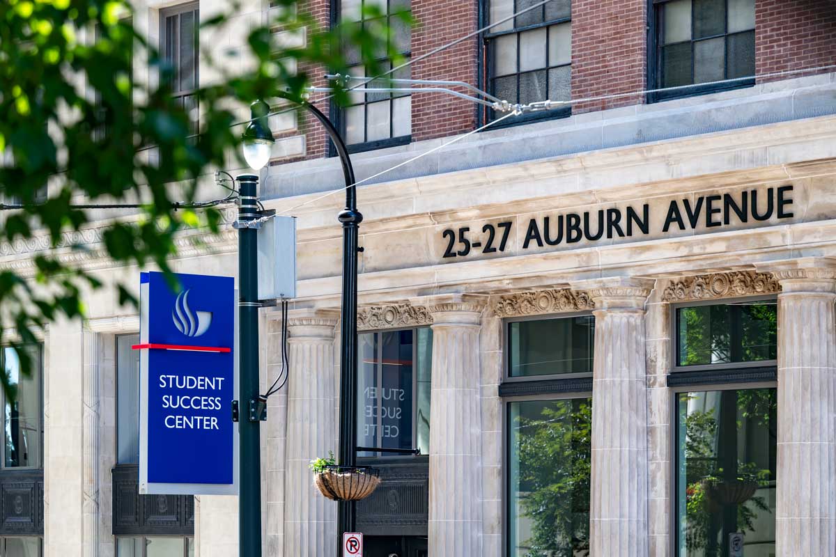 Outside of Student Success Center with a street sign