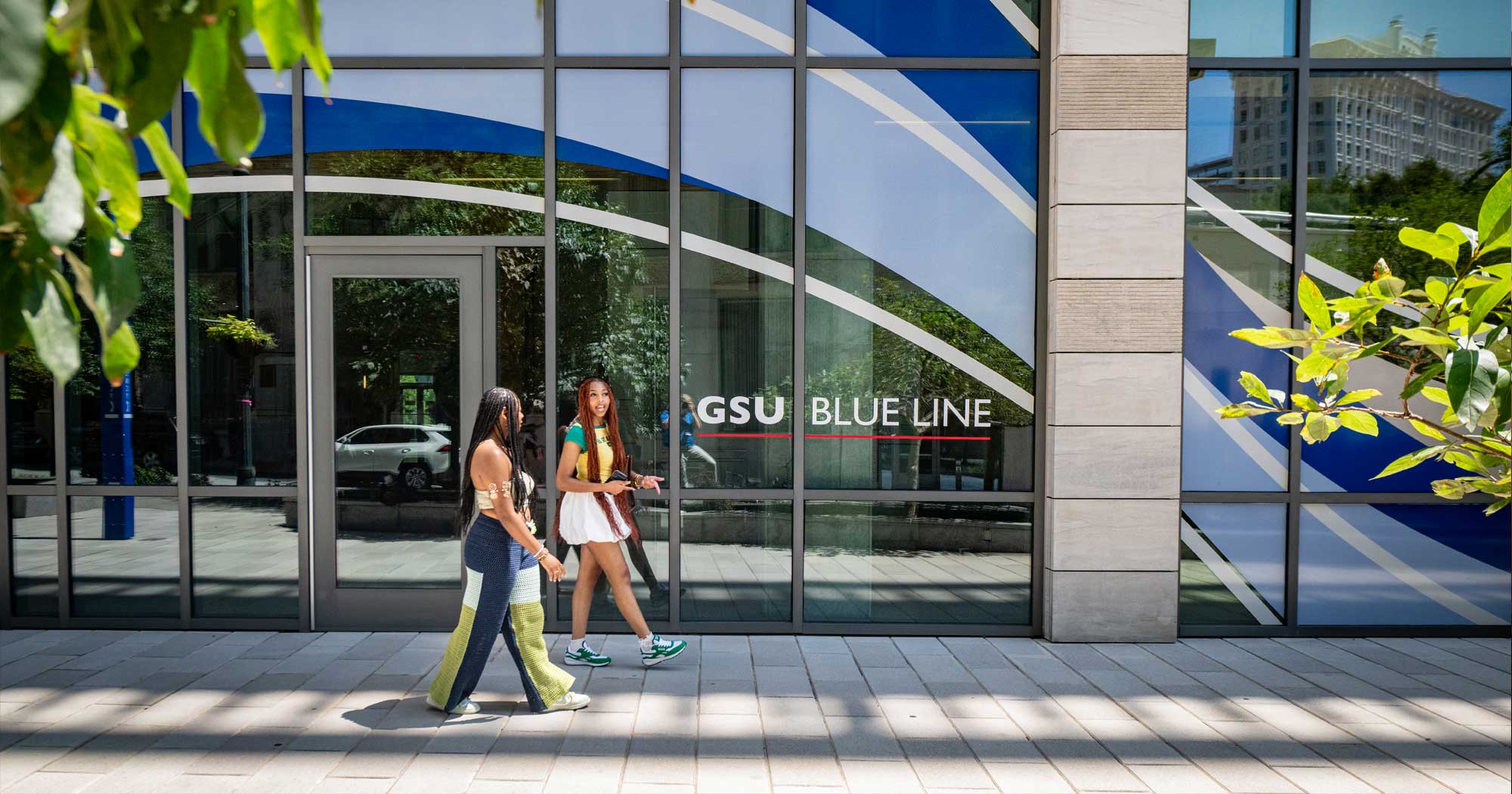 students walking past campus building