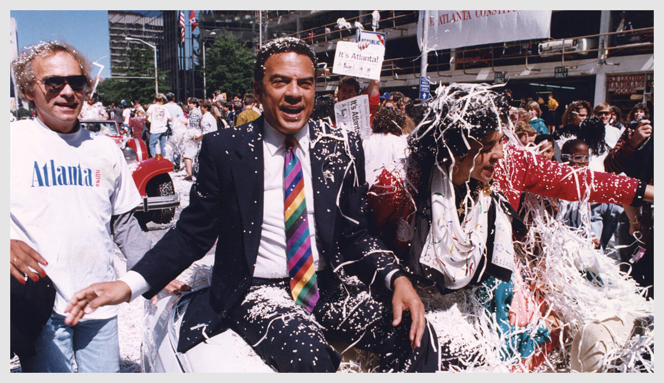 Mayor Andrew Young and his wife ride in the celebratory parade after Atlanta won the bid to host the 1996 Olympic Games. This year, the Andrew Young School of Policy Studies will also celebrate their 30th anniversary.