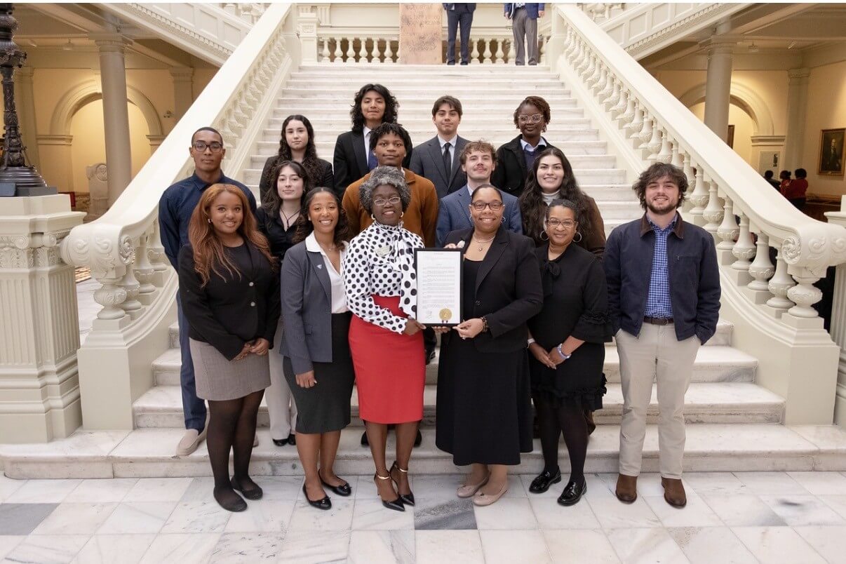 GSU Public Policy Club members and faculty sponsor Tammy Greer on the inner steps of the Capitol with Rep Jasmine Clark