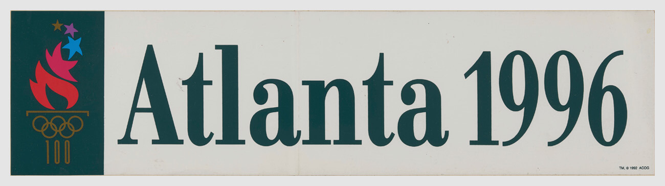 An Atlanta 1996 Olympics banner with the 100th-aniversary torch.