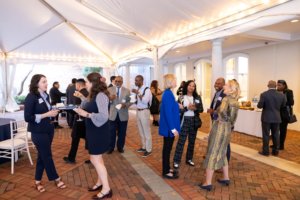 crowd mingling while standing under tented area