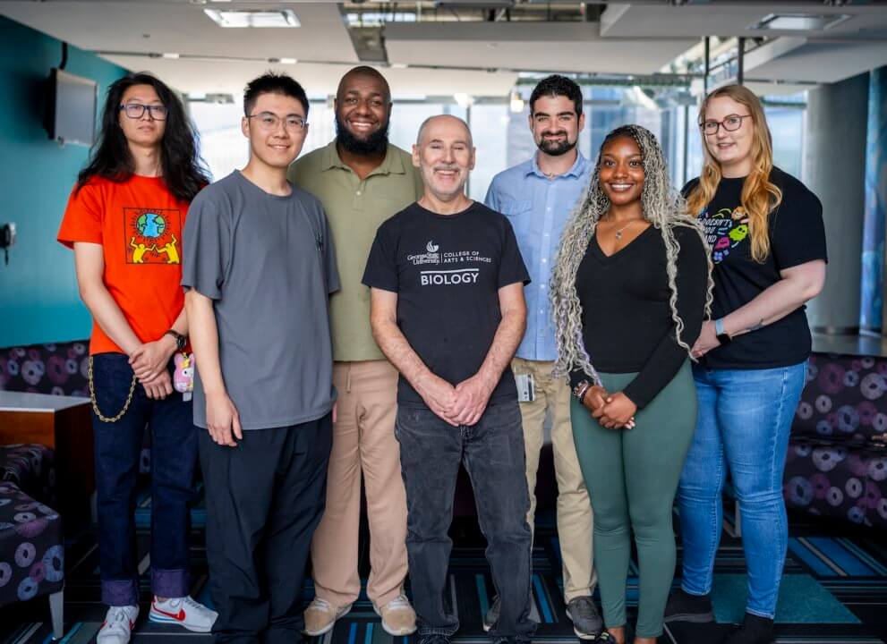 Photo of group of students and Eric Gilbert in the lab