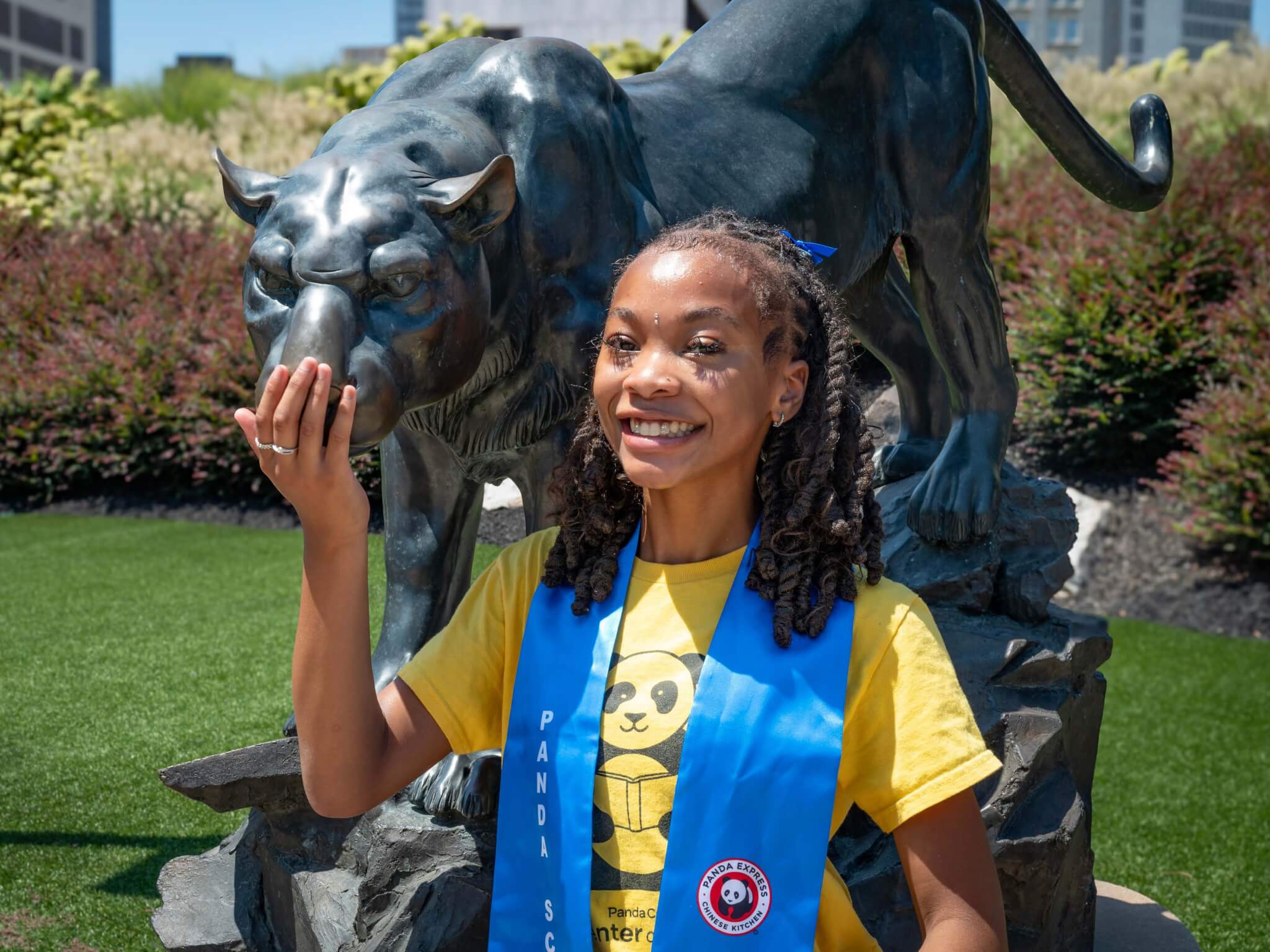 Charlaye Dennis stands in front of a panther statue on the Georgia State University campus.