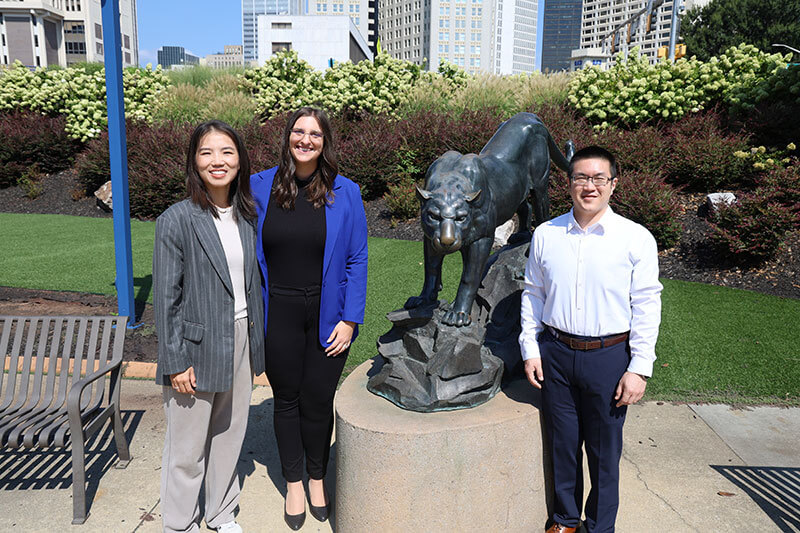 (left to right) Xiaolu Liu, Lauren Beasley and Chung Hao (Philip) Huang pose by the panther statue outside of Georgia State University's Student Center East