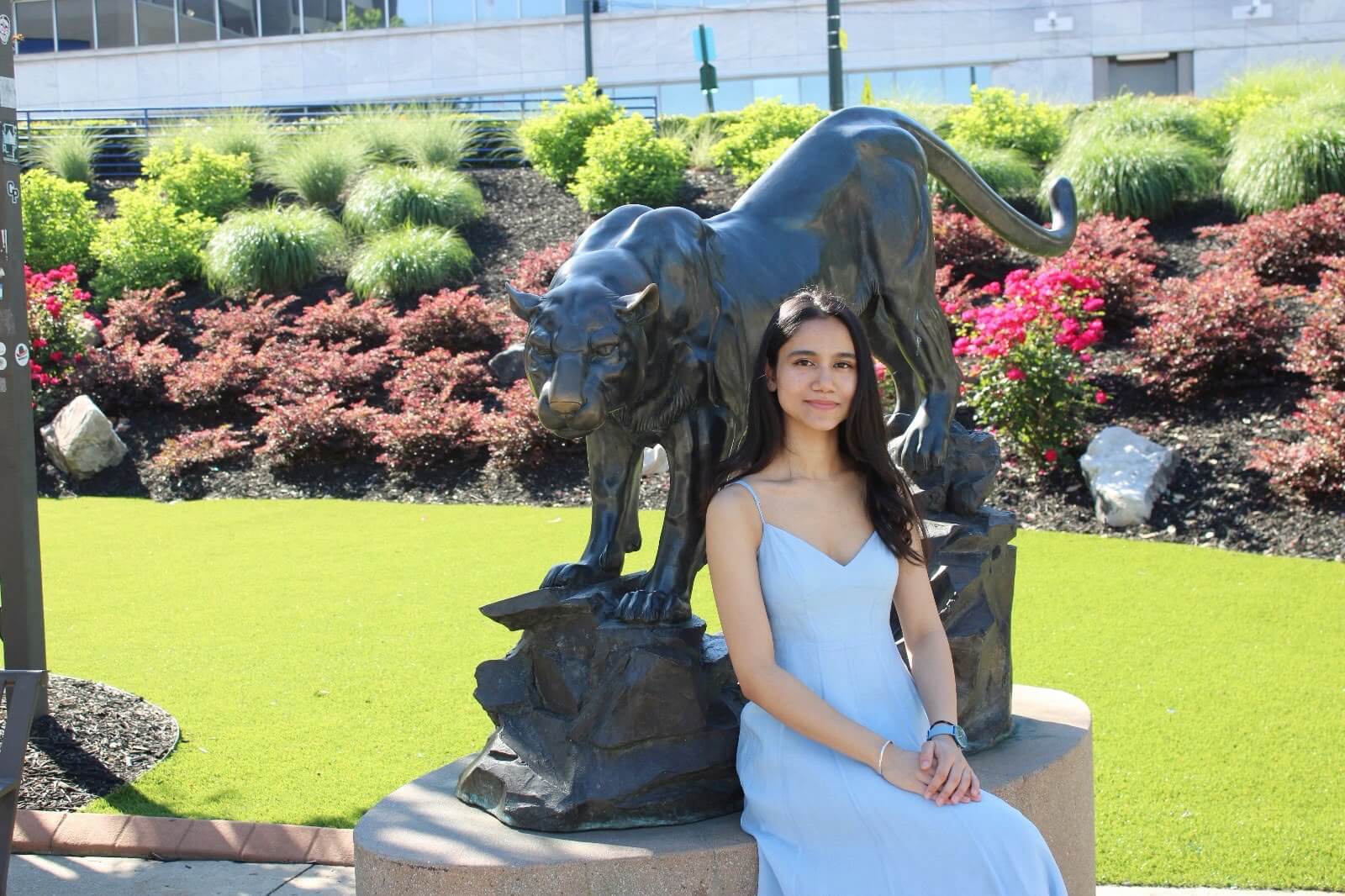 Tejal Rangdal sitting in front of the Georgia State Panther.