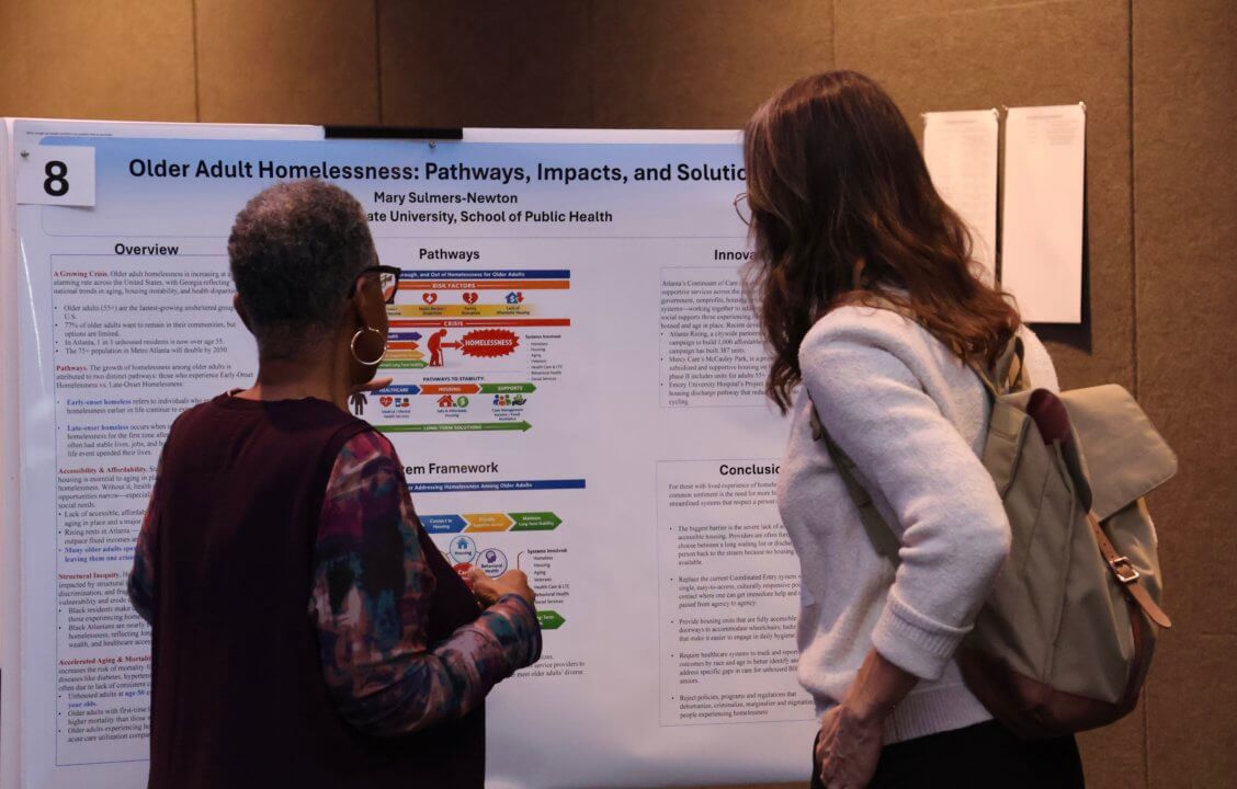 two women looking at poster board